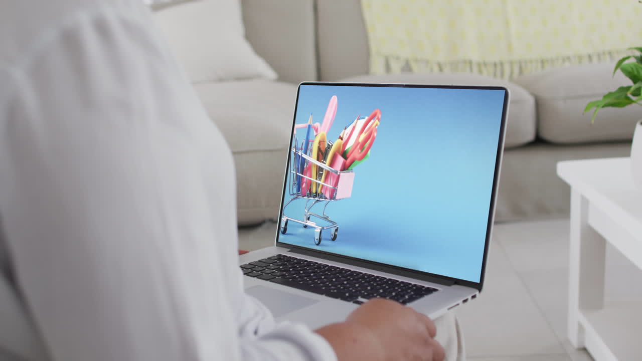 mujer biracial usando una computadora portátil en casa para comprar en línea, cámara lenta