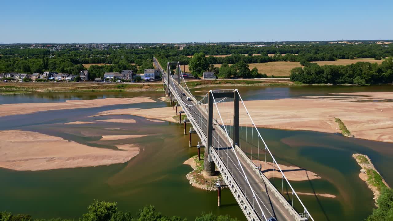 Varades suspension bridge over Loire River, France. Aerial drone forward