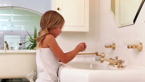 cute little girl brushing her teeth