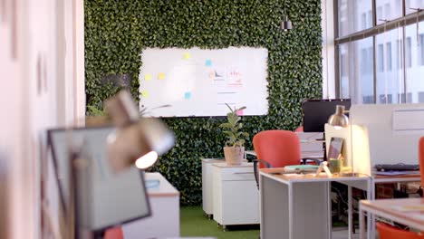 Office-interior-with-green-wall-and-whiteboard,-slow-motion