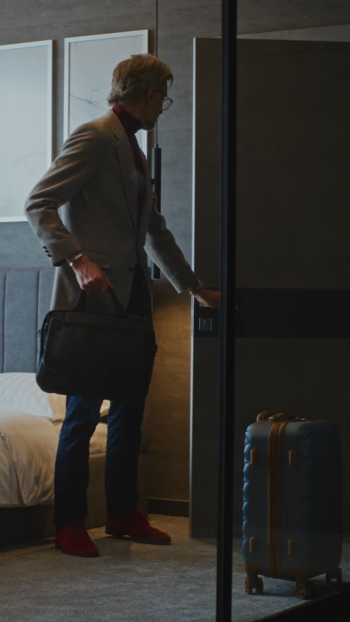 Sophisticated Gray Haired Businessman Arrives at Stylish Hotel Room (Stock Footage)