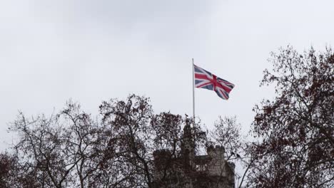 union jack flying in the wind in parliament square, london