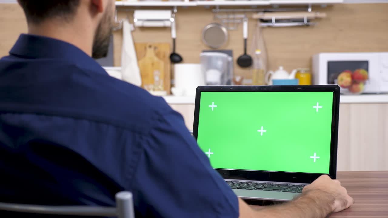 Laptop with green screen in the kitchen