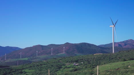 hill in andalusia with several wind turbines operating on a windy day with a clear blue sky