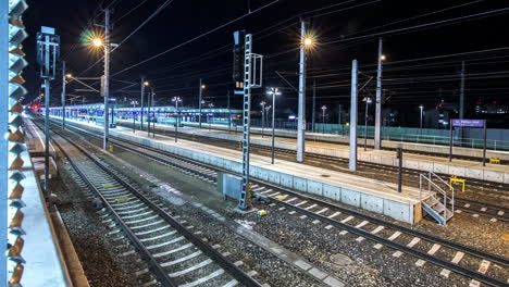 timelapse of a small train station at night