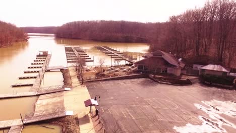 aerial footage of a marina and boat slips on an icy lake during the winter at a state park