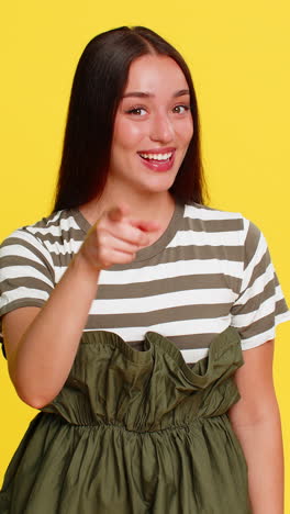 woman pointing at camera then at herself smiling playfully showing connection between you and me