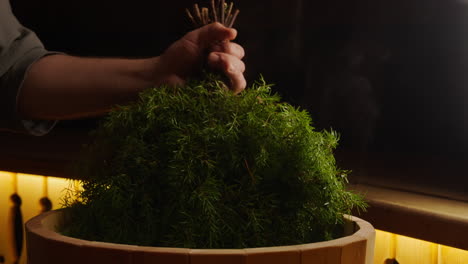 preparing a sauna with juniper branches