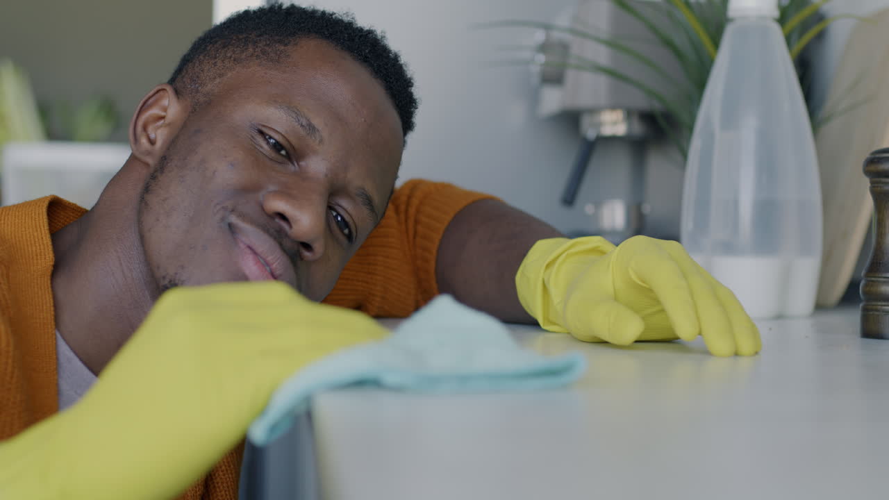 Man Cleaning Kitchen Counter
