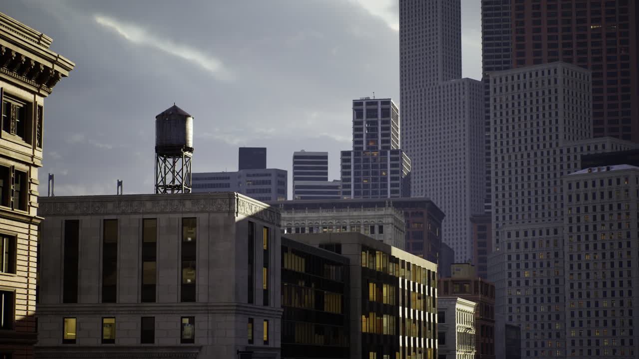 Urban skyline illuminated by soft evening light with historic water tower