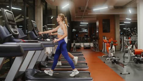 couple working out on treadmills in gym