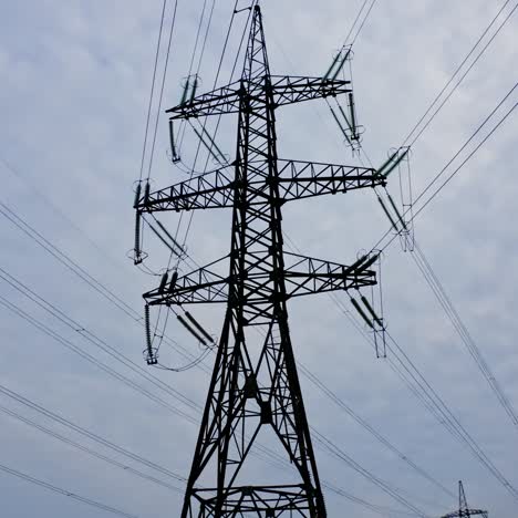 energy distribution network. electricity pylons against orange and yellow sunset. selective focus