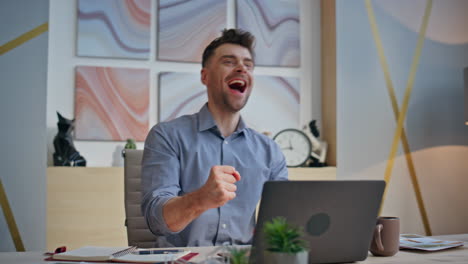 pensive boss working laptop creating ideas at desk closeup. winner man rejoicing