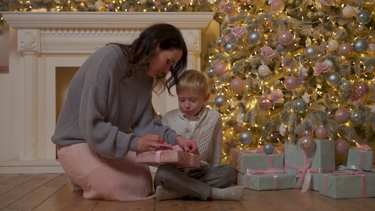Mother And Son Tie Christmas Gift Bow, Excited Little Boy Puts It Under The Tree
