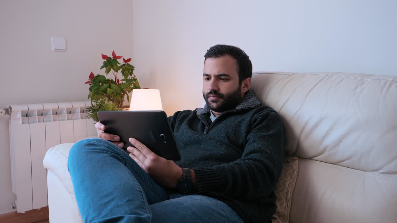 concentrated man working from his tablet