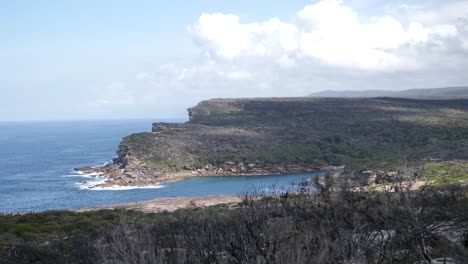 pan shot of a wide view over the coastine in the royal national park in australia near sydney during a beautiful day