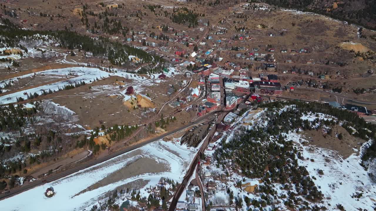 Snowy Downtown Central City Black Hawk Colorado Birds Eye view aerial drone view city historic buildings townhall winter sunny daytime blue sky Gold mining town streets casinos cars pan up circle
