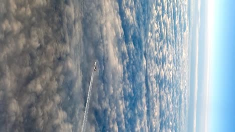 stunning flying airplane over clouds, high angle aerial view