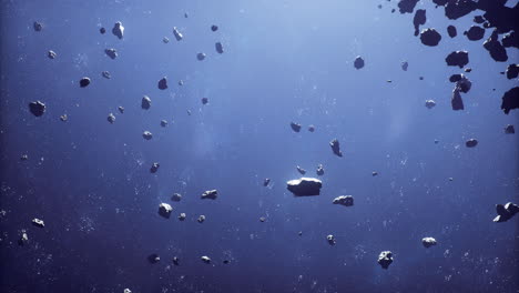 expansive view of numerous asteroids floating in deep space