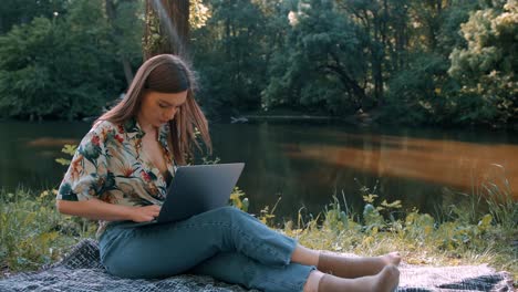 girl working on a laptop in sunny weather