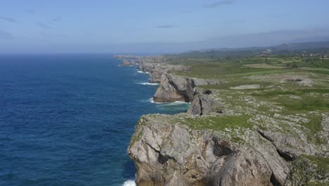 incredible jagged eroded cliffside of bufones de pria asturias spain, panoramic aerial dolly