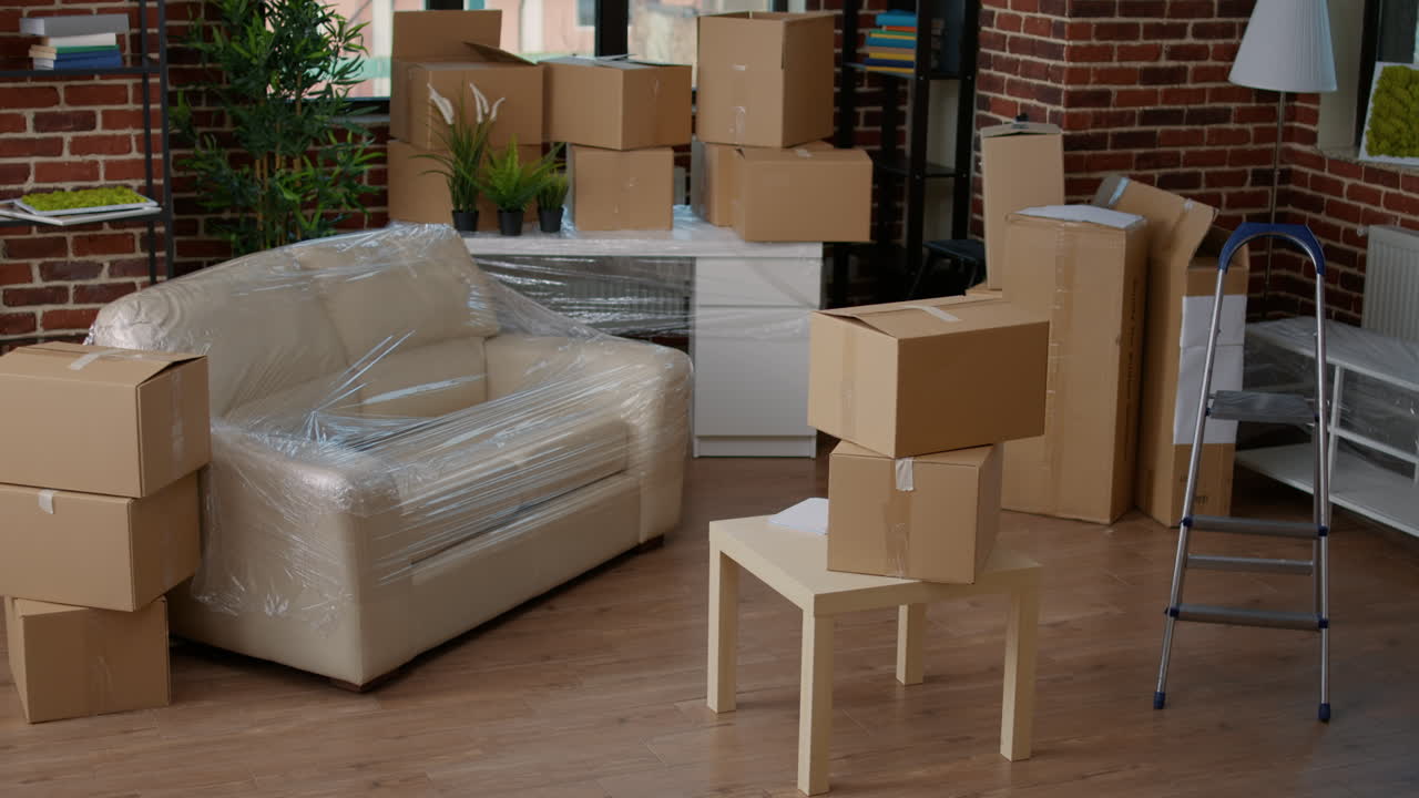 Empty apartment flat full of moving unpacked cardboard boxes
