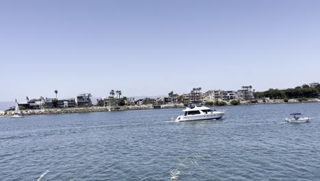 a yacht crossing the marina from left to right returning to its dock