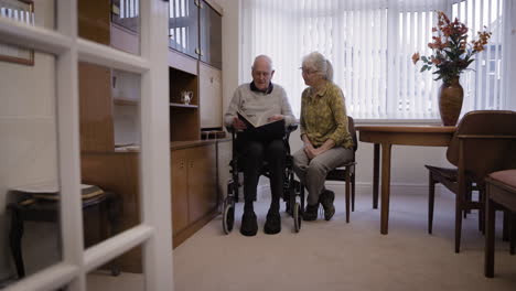 elderly couple reading in living room