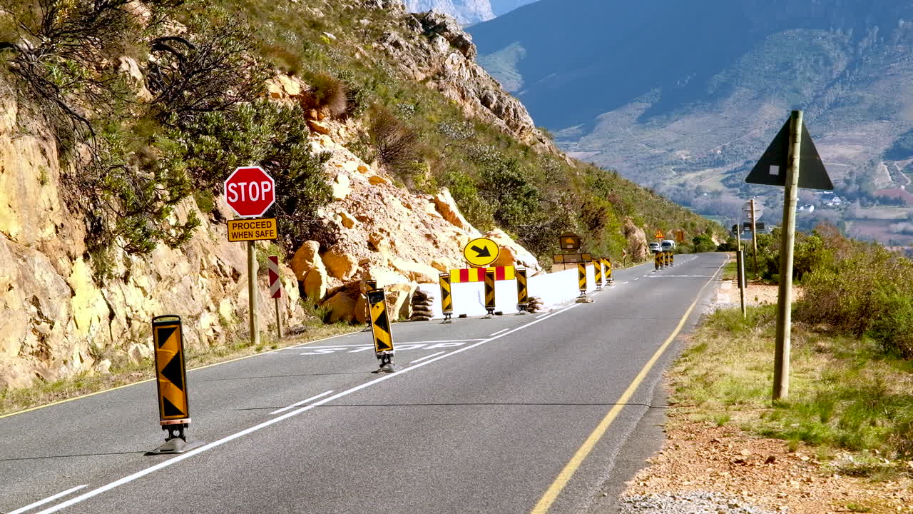 Stop and go at section of road on Franschhoek Pass impeded by dangerous rockfall