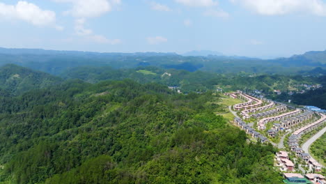 aerial ascending shot of holiday homes and hills of zhangjiajie, summer in china