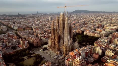 cinematic aerial drone closeup shot of la sagrada familia and catalonia housing commercial and residential buildings