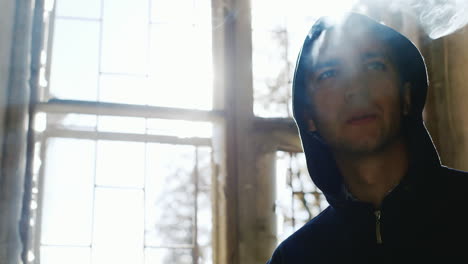 Crime-Man-Smokes-In-An-Abandoned-House-Window