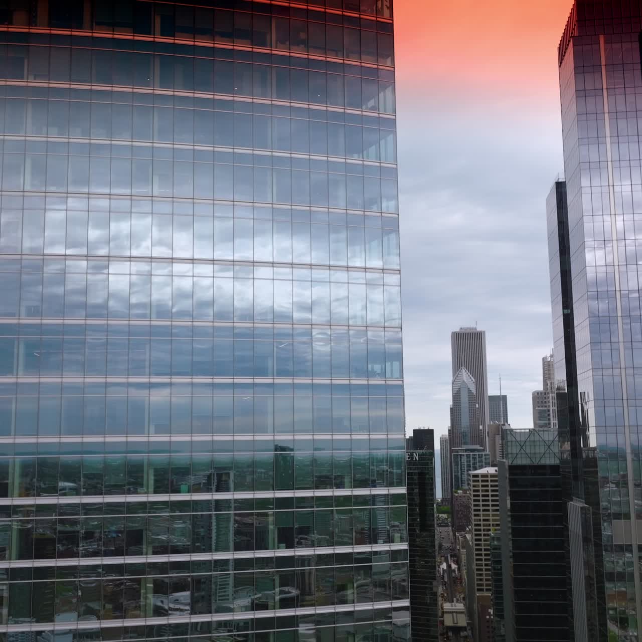 Céu rosa fascinante refletindo nas janelas espelhadas dos arranha-céus. Arquitetura impressionante da Chicago moderna