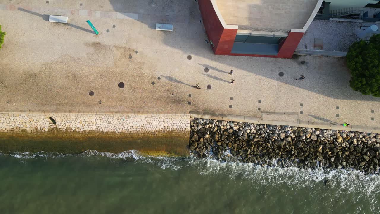 Aerial view from Lisbon riverside with people jogging,ride a bike,scooter and walking.Lisbon,Portugal
