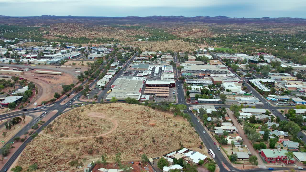 Drone view looking north over central business district of Alice Springs, Mparntwe, with Billy Goat Hill in the foreground. Northern Territory, Australia. August 2022.