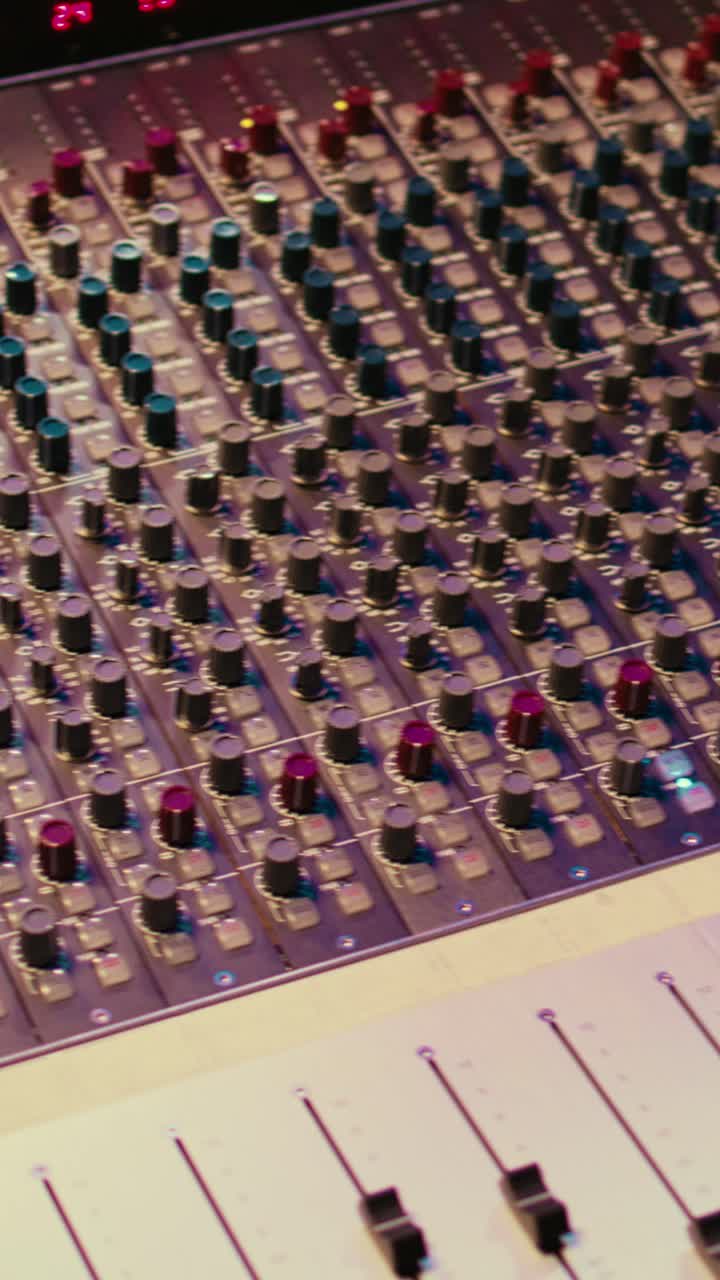 Close-up View of a Professional Audio Mixing Console
