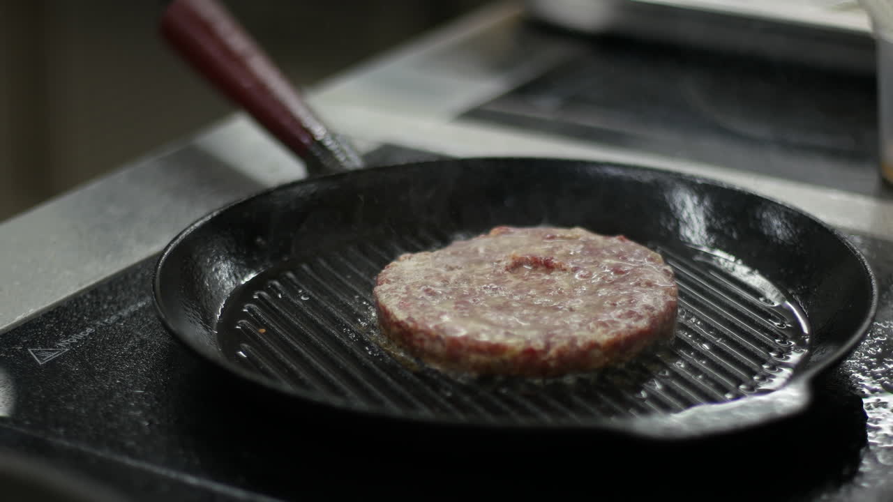Cooking a burger patty in a pan