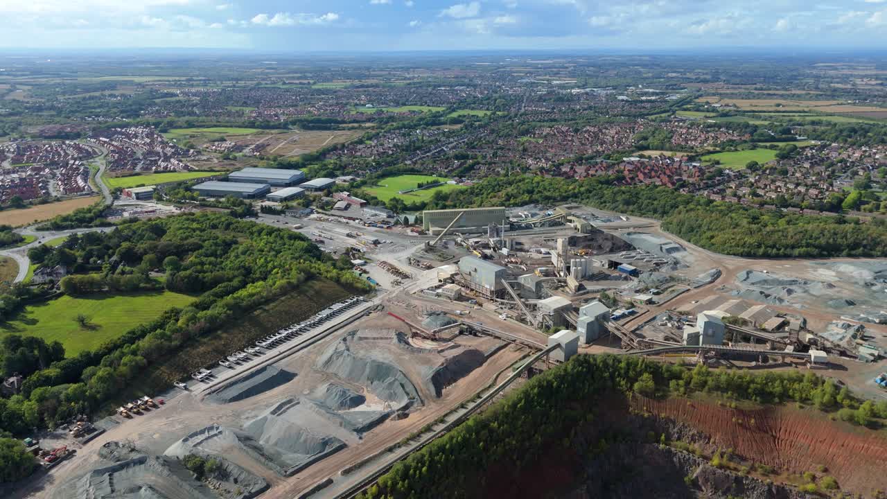 Drone view of massive industrial mining site in Coalville UK with asphalt processing and aggregates movement