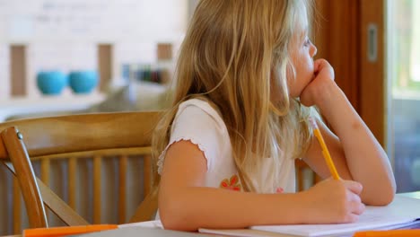 Girl-doing-her-homework-at-home-4k