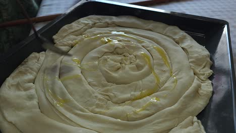 traditional pie prepared, covered with butter, ready for baking - balkans culinary delight heritage