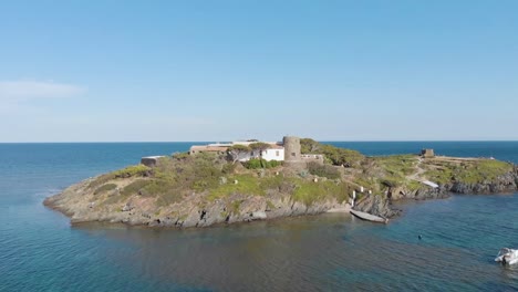 small island with old buildings in sea