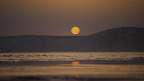 big sun over lapping sea