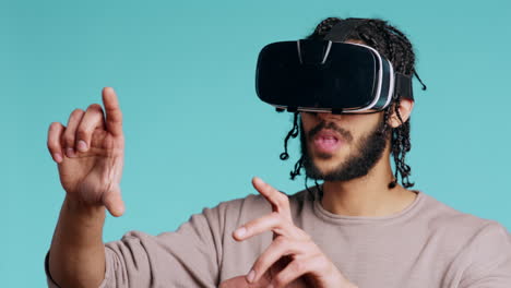 man wearing virtual reality headset, doing swiping gestures, studio background