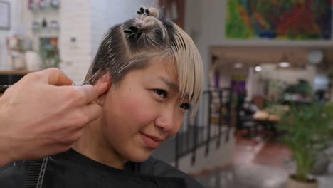 woman getting a haircut at a hair salon