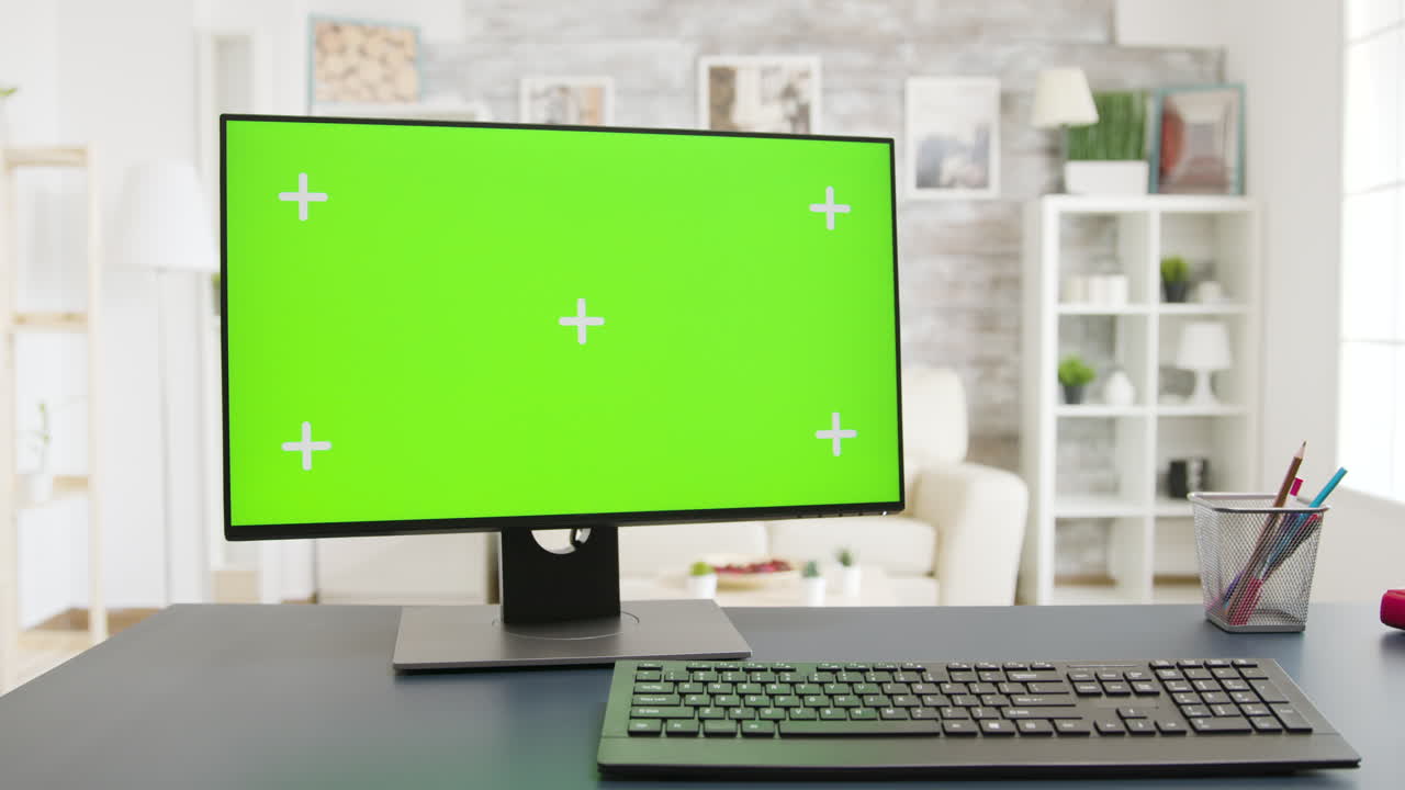 Computer with green screen on a desk