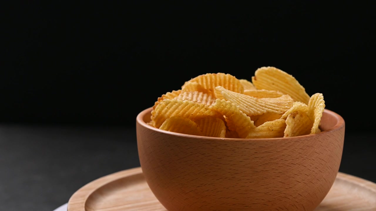 Bowl of potato chips rotating.
