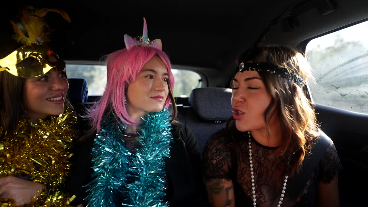 Three women celebrating in a car