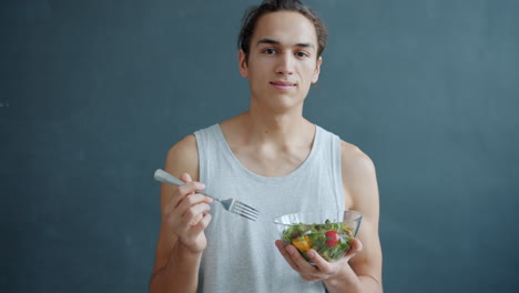young man eating a salad