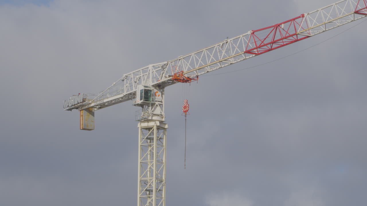 Swinging hook attached to a construction crane