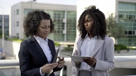 businesswomen with papers and tablet pc